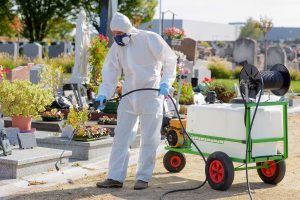 Worker Wearing Safety Gear while Spraying Pesticide