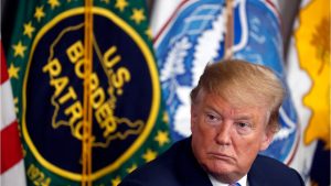 President Donald Trump Sits in Front of U.S. Border Patrol Flag