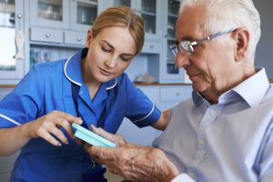 Nurse Encouraging Elder Man to Take Pills
