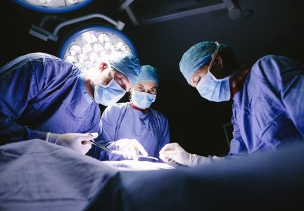 Group of surgeons doing surgery in hospital